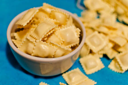 preparing ravioli with red sauceの写真素材