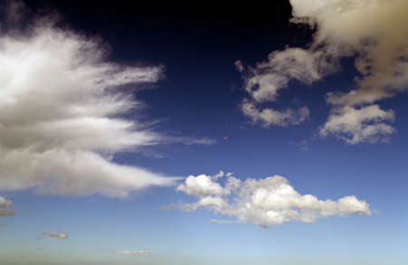Cloudy sky with small moon