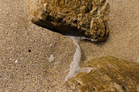 Background of sand, stones and waterの写真素材