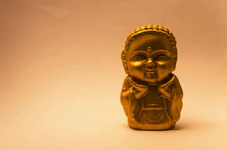 colorful buddha figures with brown background.の写真素材