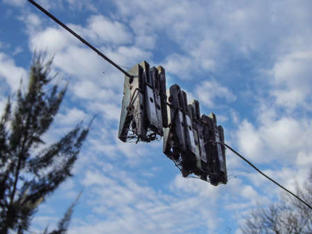 old clothespins hanging on a rope with sky background