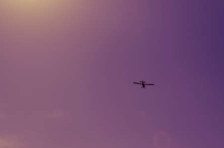 Small plane flying through the sky. background