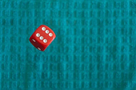 red dice floating on a turquoise backgroundの写真素材