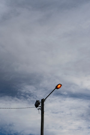Lamp post with blue sky and white clouds in the background.の写真素材