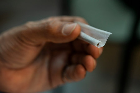 Cigarette in a hand of a man, close-upの写真素材