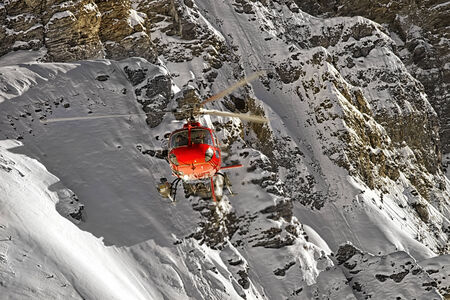 Red helicopter at swiss alps in winterの写真素材