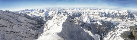 Swiss alpine peaks landscape panorama of Bern Highland Jungfrau region with Niesen peak helicopter...