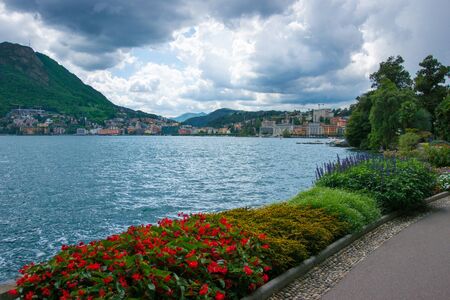 Lake Lugano view at stormy weather from city parkの写真素材