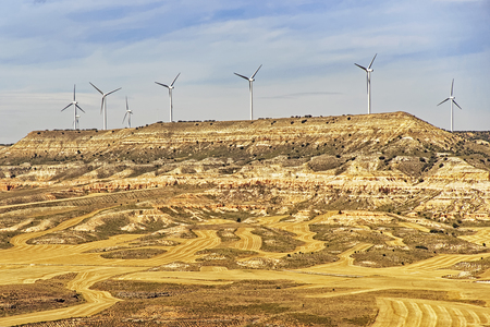 Wind turbines on the hill in front of blue sky at summer sunny weatherのeditorial素材