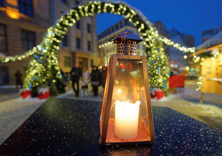 Lantern on a table on the background of the Christmas market in Riga Dome square Latviaの写真素材