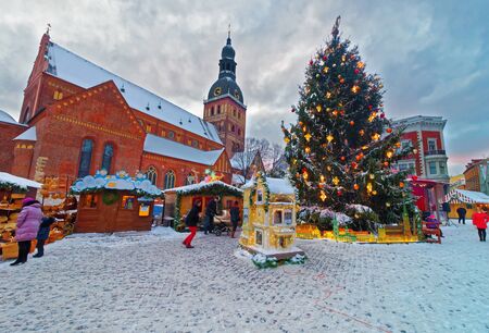 RIGA, LATVIA - DECEMBER 28, 2014: Traditional european Christmas market in Riga Dome square Latvia on a snowy winter dayのeditorial素材