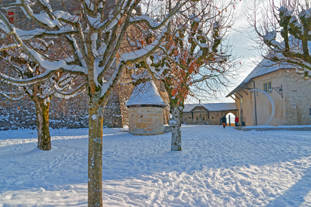 GRUYERE, SWITZERLAND - DECEMBER 31, 2014: Esplanade in front of the castle of Gruyeres in Switzerland on a sunny winter day.のeditorial素材