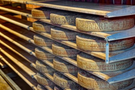 Aging cheese in a cellar of the Maison du Gruyere cheese factory in Switzerland. Gruyere is a famous swiss cheese generally known as one of the finest cheeses for fondues and for bakingのeditorial素材