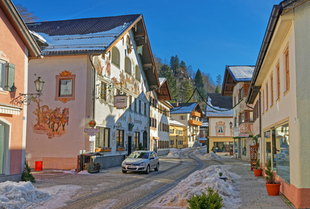 Enchanting Upper Bavarian-styled homes in Garmisch-Partenkirchen, adorned with painted scenes. Almost every buildings in Garmisch-Partenkirchen have unique murals on the outside walls of the buildingsの写真素材