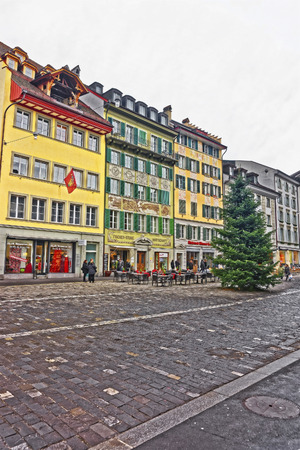 LUCERNE, SWITZERLAND - JANUARY 04, 2015: Colorful architecture of Lucerne on the right bank of the River Reuss at a picturesque square Muhlenplatz in Switzerland.のeditorial素材