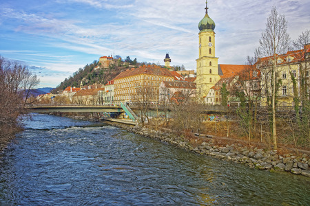 GRAZ, AUSTRIA - JANUARY 7, 2014: River view to the Franciscan church and Clock tower of the Castle Hill in Graz of Austria in Januaryのeditorial素材