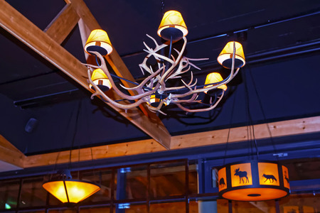 RUKA, FINLAND - JANUARY 9, 2013: Chandeliers with reindeer horns and animals decor in a restaurant in Ruka village in Finland in the Arctic pole circleのeditorial素材