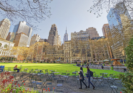 Tourists looking at Green Lawn and Skyscrapers in Bryant Park in Midtown Manhattan, New York, USA.のeditorial素材