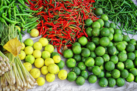 Asian farmer market selling fresh fruit and vegetables in Vietnam. Pepper, lemon, lime and onion.の写真素材