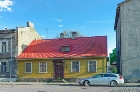 Ventspils, Latvia - May 8, 2016: Yellow painted Old house with red roof in Ventspils in Latvia. It is a city in the Courland region of Latvia. Latvia is one of the Baltic countriesのeditorial素材