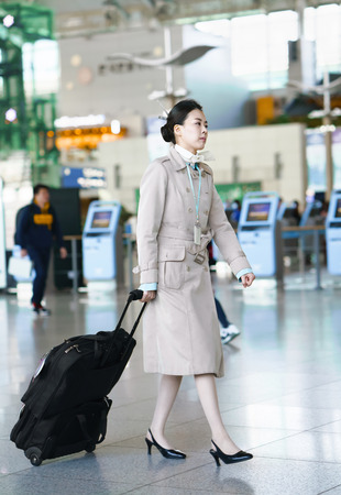Incheon, South Korea - February 15, 2016: Asian Korean female air flight hostess at Incheon International airport. It is one of the largest and busiest world airports.のeditorial素材