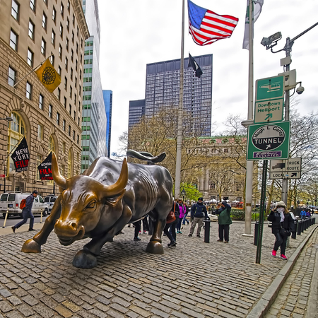 New York, USA - April 24, 2015: Charging Bull at Wall Street in Financial District in Lower Manhattan, New York, USA. Tourists in the streetのeditorial素材