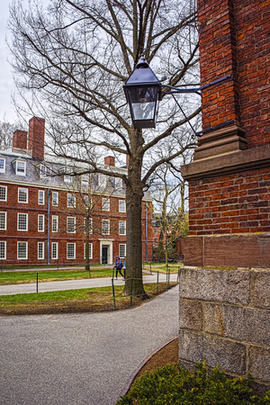 Cambridge, USA - April 29, 2015: Dormitory building at Harvard Yard of Harvard University in Cambridge, Massachusetts, MA, USA. Tourists in the streetのeditorial素材