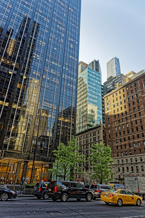 New York, USA - May 6, 2015: Intersection of Avenue of the Americas, or Sixth Avenue, and West 55th Street in Midtown Manhattan. Tourists in the streetのeditorial素材