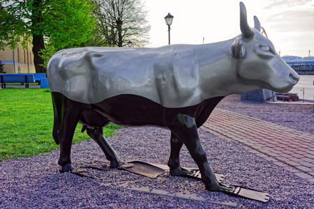 Ventspils, Latvia - May 8, 2016: Silver Cow Figure in the Street of Ventspils, Latvia. Ventspils is a town in Courland region of Latvia. Latvia is one of the Baltic countries.のeditorial素材