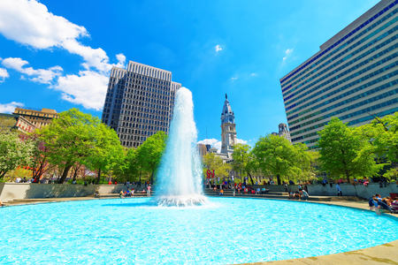 Philadelphia, USA - May 4, 2015: Splash of water in fountain in Love Park of Philadelphia, Pennsylvania, USA. Tourists in the park. City Hall on the backgroundのeditorial素材