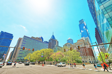 Philadelphia, USA - May 4, 2015: JFK boulevard and Penn Center with skyline of skyscrapers in Philadelphia, Pennsylvania, USA. It is central business district in Philadelphia. Tourists in the streetのeditorial素材