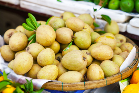 Asian street farmer market selling fresh lamut fruit in Hoi An, Vietnam.の写真素材