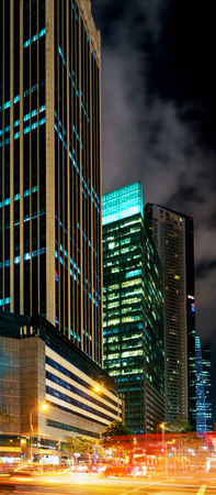 Singapore, Singapore - March 1, 2016: Skyscrapers in the center of the Downtown Core in Singapore at twilight. Car traffic in the road.のeditorial素材