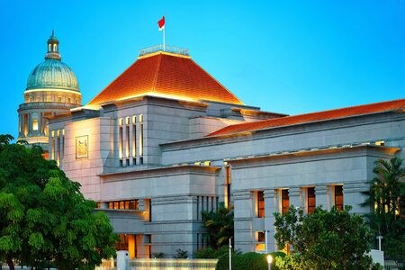 Parliament and Old Supreme Court Building at Boat Quay in Singapore at night. It is illuminated with light.のeditorial素材