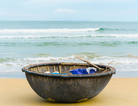 Sea and Bamboo waterproof round fishing boat at the China Beach in Danang, in Vietnam. It is also called Non Nuoc Beach. South China Sea and on the background.の写真素材