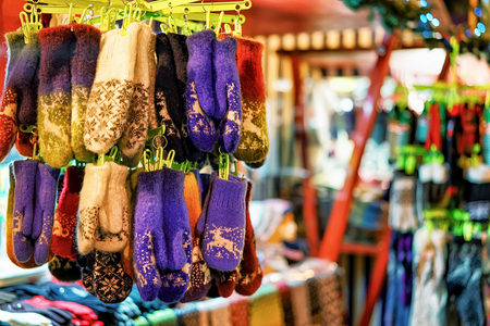 Colorful warm gloves being sold at the Christmas Market in Riga, Latvia. The market was full of various festive goods, souvenirs, clothes, traditional food and hot drinks. Selective focusの写真素材