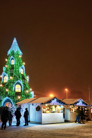 Vilnius, Lithuania - December 27,2015: Vilnius Christmas Market and Christmas tree in the background at the Cathedral Square in Vilnius, Lithuania. Snow fallingのeditorial素材