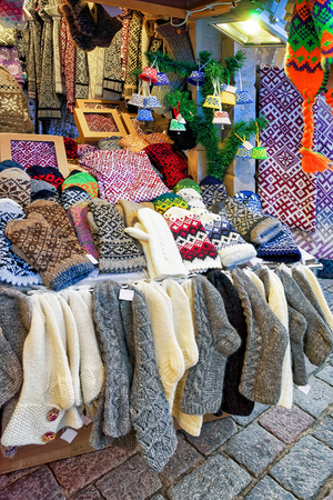 One of the stalls with woolen clothes at the Christmas Market in Riga, Latvia. During the market people can find different festive goods, souvenirs, sweets, traditional food and drink. Selective focusの写真素材