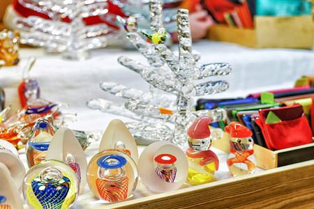 Riga, Latvia: Little glass figurines and tree at the stall during the Christmas market in old Riga, Latvia. Selective focusの写真素材