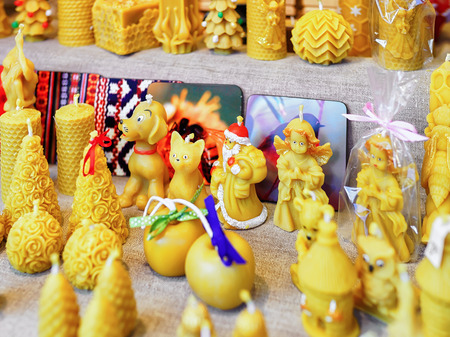 Festive candles in the form of different animals and angels displayed for sale at the Christmas market in Riga, Latvia. At the market people can buy festive goods, souvenirs, clothes and food.の写真素材