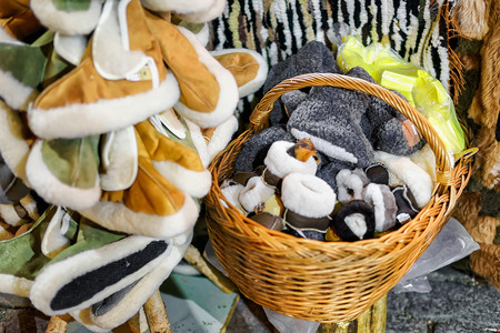 Warm handmade slippers presented in the basket at one of the stands during the Christmas market in...