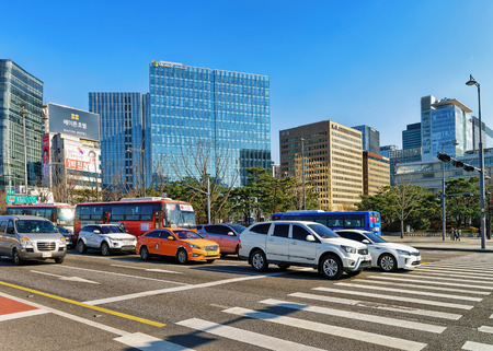 Seoul, South Korea - March 11, 2016: Car traffic, pedestrian crossing and Modern skyscrapers in Jung district, Seoul, South Koreaのeditorial素材
