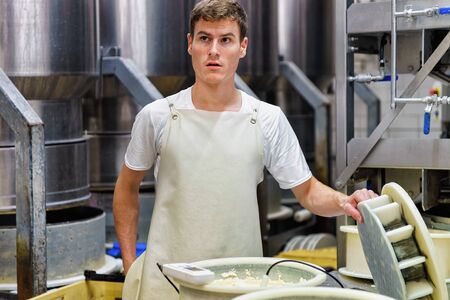 Evillers, France - August 31, 2016: Gruyere de Comte Cheese in the special forms at the dairy in...