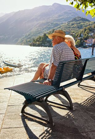 Ascona, Switzerland - August 23, 2016: Senior Couple sitting on the bench of the embankment of Ascona luxurious resort on Lake Maggiore, Ticino canton, Switzerland.のeditorial素材