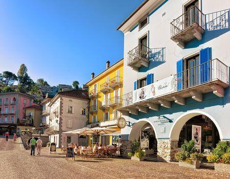 Ascona, Switzerland - August 23, 2016: Hotels and restaurants at the luxurious resort in Ascona on Lake Maggiore of Ticino canton, Switzerland. People on the background.のeditorial素材