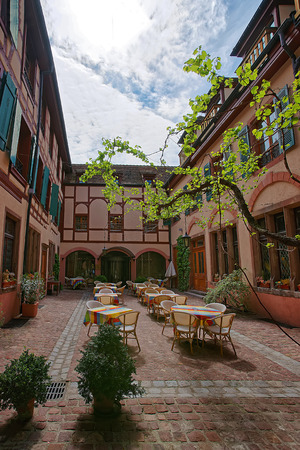 Inner yard of Colorful half-timbered houses in the old town in Colmar, Haut Rhin in Alsace, France. People on the backgroundの写真素材