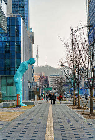 Seoul, South Korea - March 14, 2016: Man figure at the hotel in Myeongdong street in Jung district of Seoul, South Korea. People on the backgroundのeditorial素材