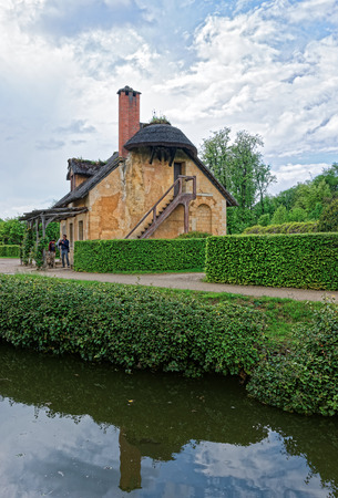 Paris, France - May 5, 2012: Old village of Marie Antoinette at the Palace of Versailles in Paris in France. People on the backgroundのeditorial素材