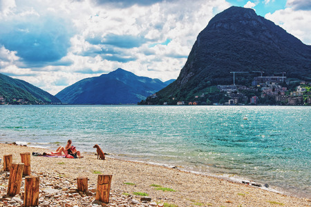 Lugano, Switzerland - August 26, 2013: People on the Beach at the promenade of the luxurious resort in Lugano on Lake Lugano in Ticino canton of Switzerland.のeditorial素材