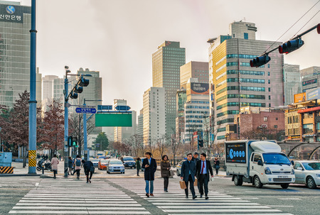 Seoul, South Korea - March 14, 2016: Pedestrians on the road and Skyscrapers of Jongno district in...